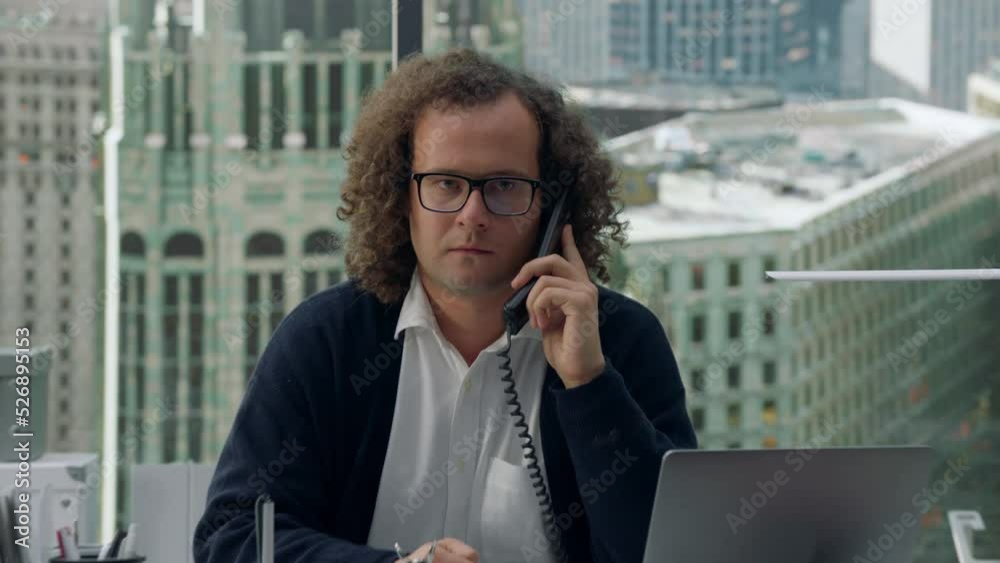 CRASH ZOOM Crazy nerdy looking manager screaming into the phone during the call, negotiations gone wrong