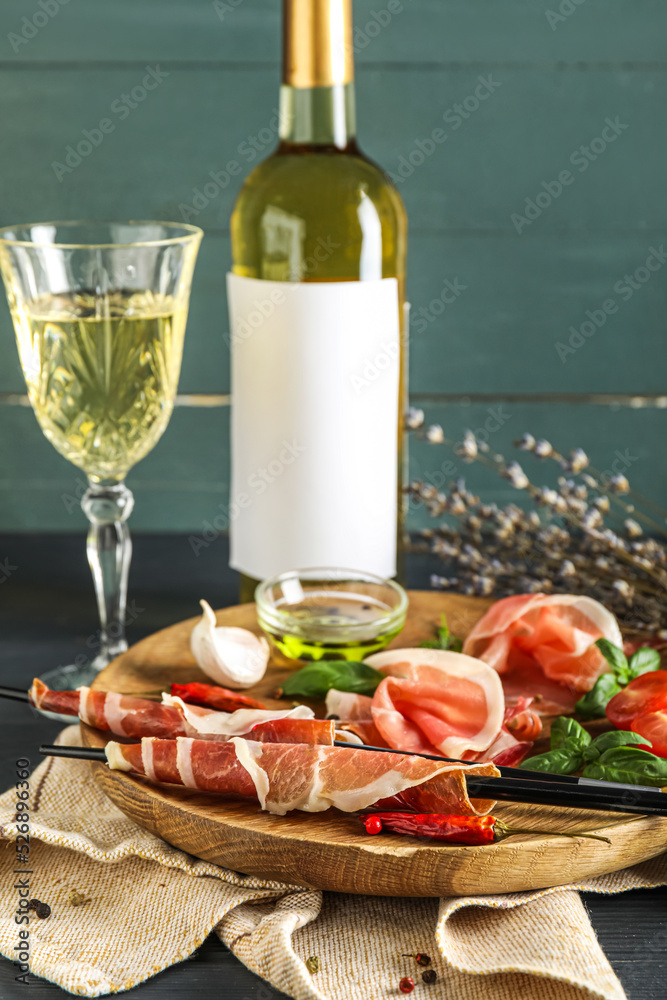 Wooden plate with delicious jamon on table, closeup