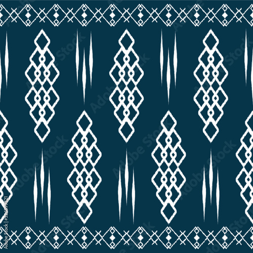 Ikat ethnic background vector. Seamless pattern of white diamond shapes abstrac geometrics on navy blue background. photo