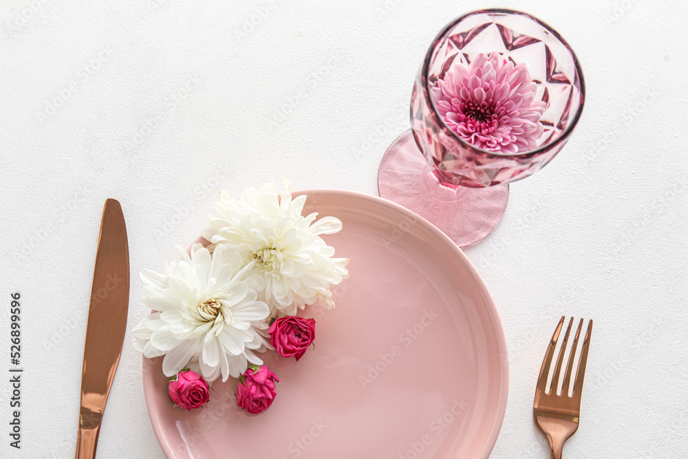 Beautiful table setting with chrysanthemum flowers and roses on white background Beautiful table setting with chrysanthemum flowers and roses on white background