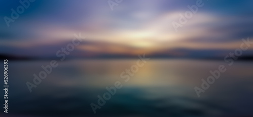 Abstract background of evening sky and sea  blurry pattern. Water pattern at sunset and blur. Lake  clouds  yellow light from the twilight sun.