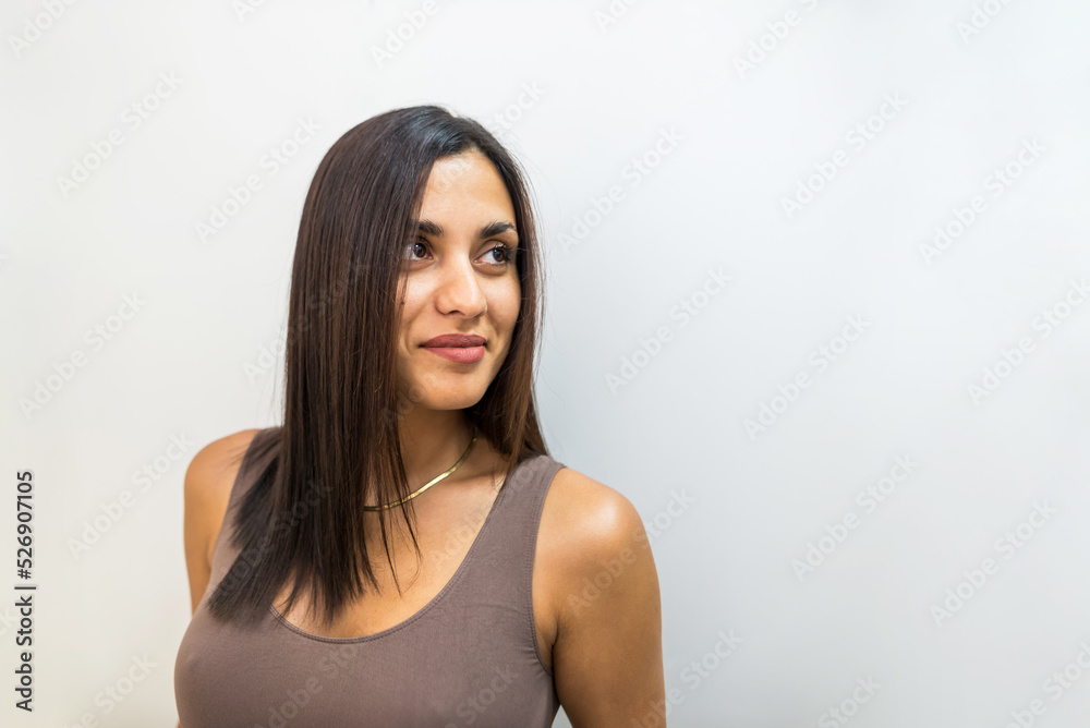 Close-up of a beautiful sexy brunette with a big bust on a white background. Close-up of a beautiful sexy brunette with a big bust on a white background.