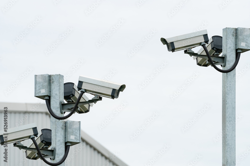 CCTV security camera video system for safety installed outside the warehouse of factory building. Closed circuit television . CCTV electronic security system. Video surveillance camera technology. CCTV security camera video system for safety installed outside the warehouse of factory building. Closed circuit television . CCTV electronic security system. Video surveillance camera technology.