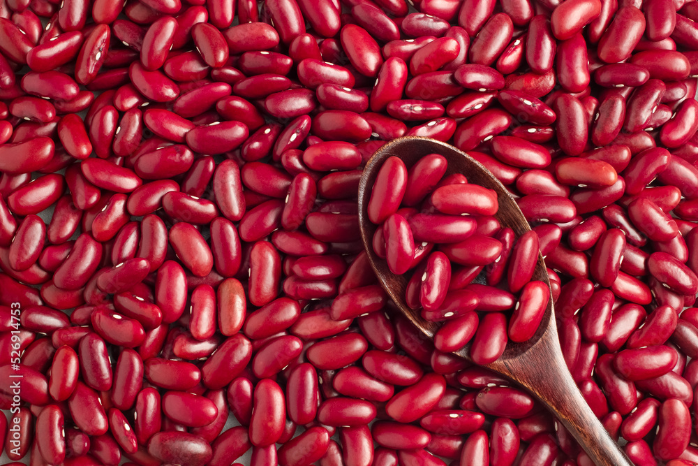 Close-up photo of several red kidney beans and wooden spoon,top view,flay lay,top-down. Close-up photo of several red kidney beans and wooden spoon,top view,flay lay,top-down.