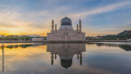 Putra Mosque is the principal mosque of Putrajaya, Malaysia. Building on the left is Perdana Putra which is Malaysian Prime Minister's office. (time-lapse) photo
