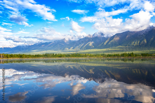 Landscape with mountains reflecting in the water on summer sunny day. Buryatia, Tunkinskaya valley