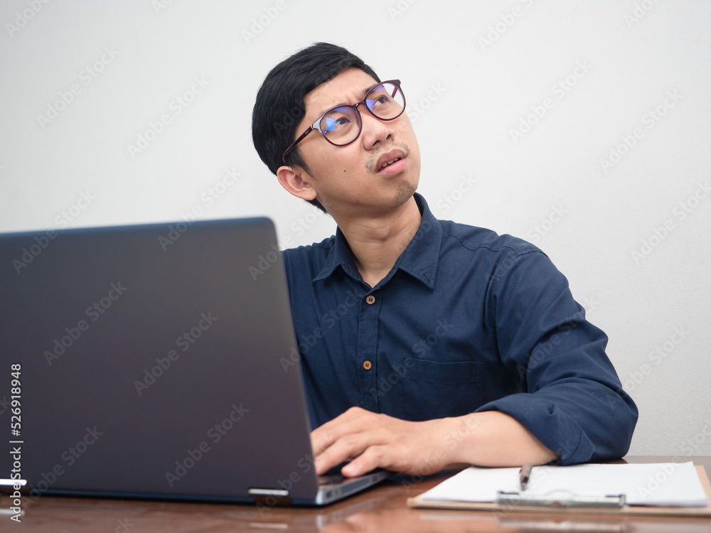Asian businessman using laptop feels strain with working Asian businessman using laptop feels strain with working