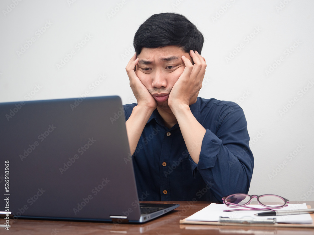 Male employee sit at working table feels bored with work Male employee sit at working table feels bored with work