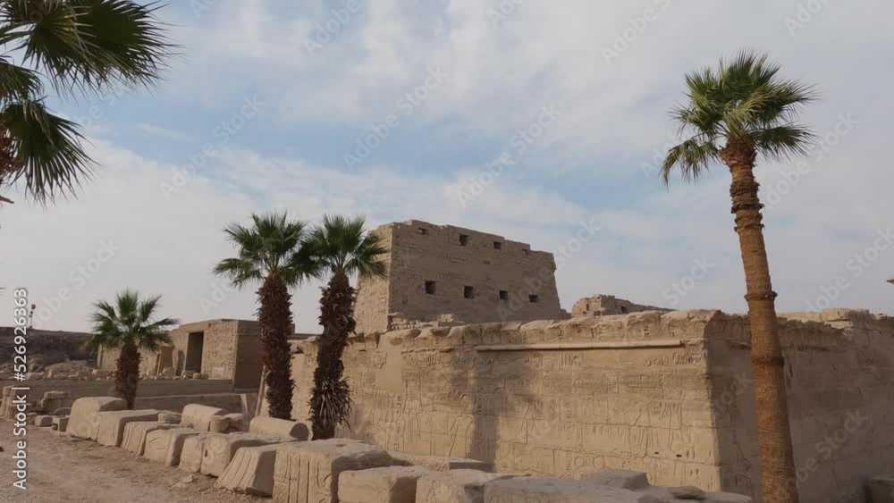 Karnak Temple In Luxor, Egypt. Palm trees and landmark ruins Karnak Temple In Luxor, Egypt. Palm trees and landmark ruins