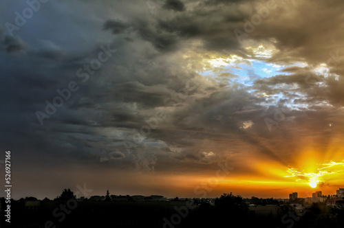 Summer dramatic sunset landscape with dark clouds