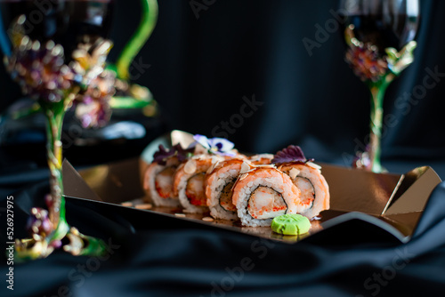 sushi rolls and glasses with wine romantic evening