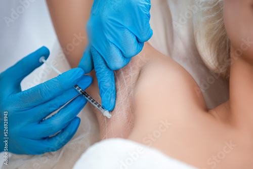 Closeup of Young Caucasian Woman Getting Armpits Injection in Beauty Salon