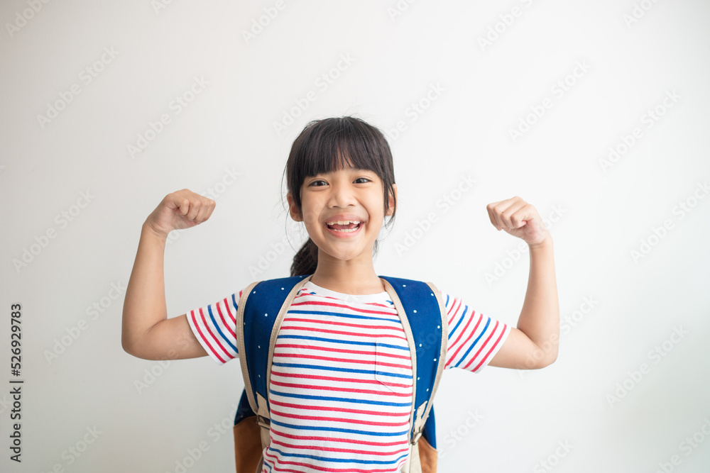 Happy Asian children showing her strong hands Happy Asian children showing her strong hands