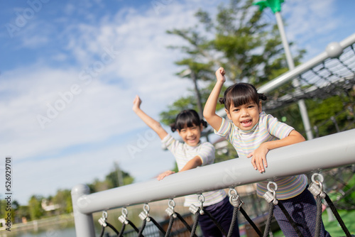 Little school kids climbing in the school playground.