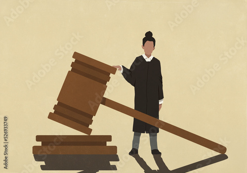 Female judge standing at large gavel
 photo