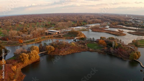 Glencoe, Illinois, USA : Aerial drone forward moving shot over Chicago Botanic Garden during dry autumn season with small lakes during evening time. photo