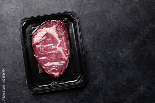 Fotografie Vacuum packed beef steak. Raw ribeye steak