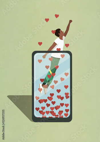 Man ascending from smart phone with hearts
 photo
