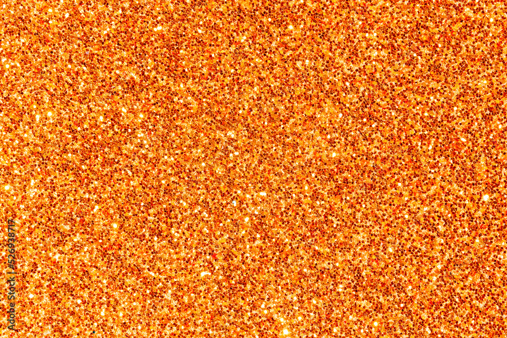 Surface background covered with orange shiny sequins. Orange grainy ground background. Surface background covered with orange shiny sequins. Orange grainy ground background.