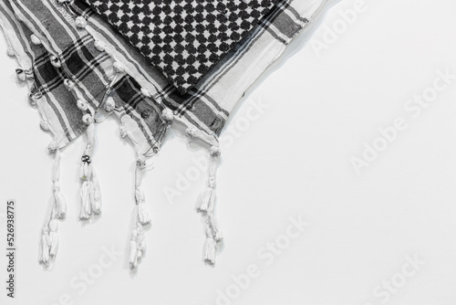 A traditional head-tied garment 'Keffiyeh' or 'Puşi' on a white isolated background. Keffiyeh is widely used in the Middle East and the Arab World. photo