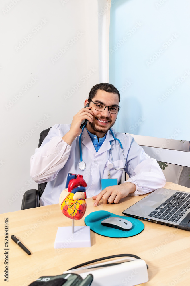 Doctor talking on the phone with his patient. Doctor talking on the phone with his patient.