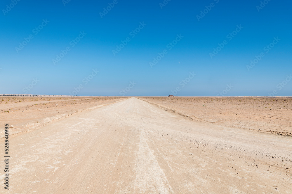 Sandy Track going into the desert with clear blue sky, copy space