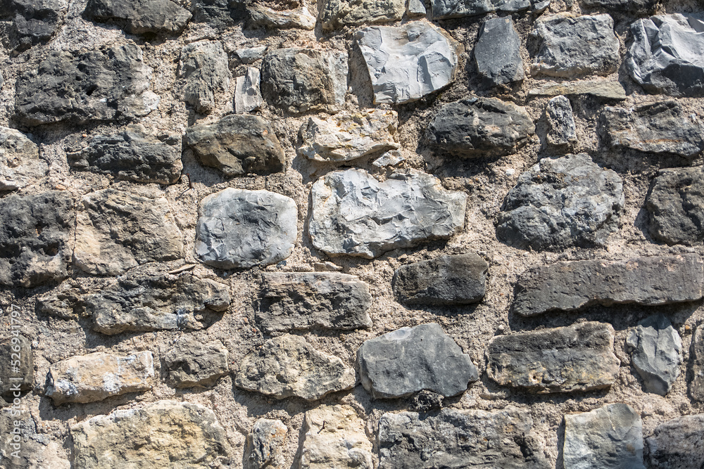 Architecture textures, detailed view of a traditional paired masonry, mixed granite and limestone wall, used on a fortress castle wall Architecture textures, detailed view of a traditional paired masonry, mixed granite and limestone wall, used on a fortress castle wall