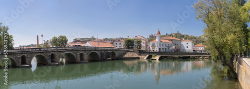 Ultra panoramic view at the Tomar city downtown, with Nabão river, old city bridge, Pouchão park and the iconic Tomar Castle and Convent of Christ