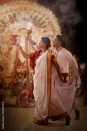 Bengali couple performing dhunuchi dance on the occasion of Durga Puja photo