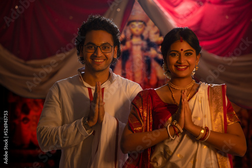 Portrait of young Bengali Couple greeting on the occasion of Durga Puja photo