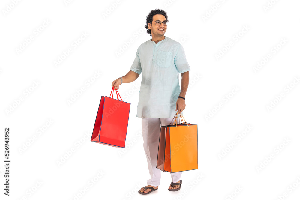 Portrait of a Bengali man carrying shopping bags against white background Portrait of a Bengali man carrying shopping bags against white background