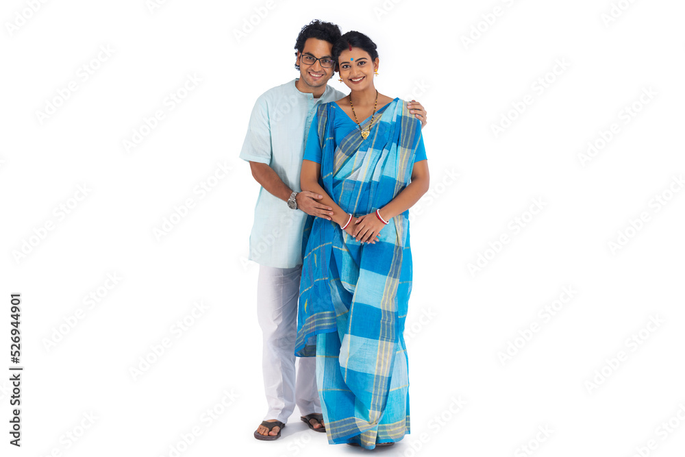 Portrait of young Bengali couple standing against white background Portrait of young Bengali couple standing against white background