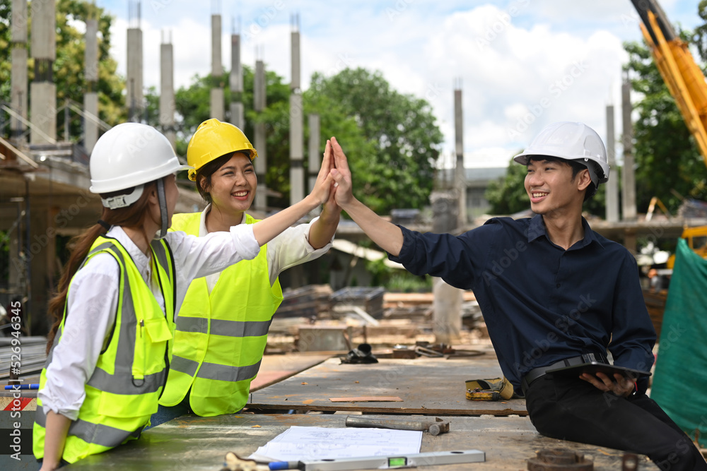 Architect team and engineers are making high five together. Industry, Engineer, construction concept Architect team and engineers are making high five together. Industry, Engineer, construction concept