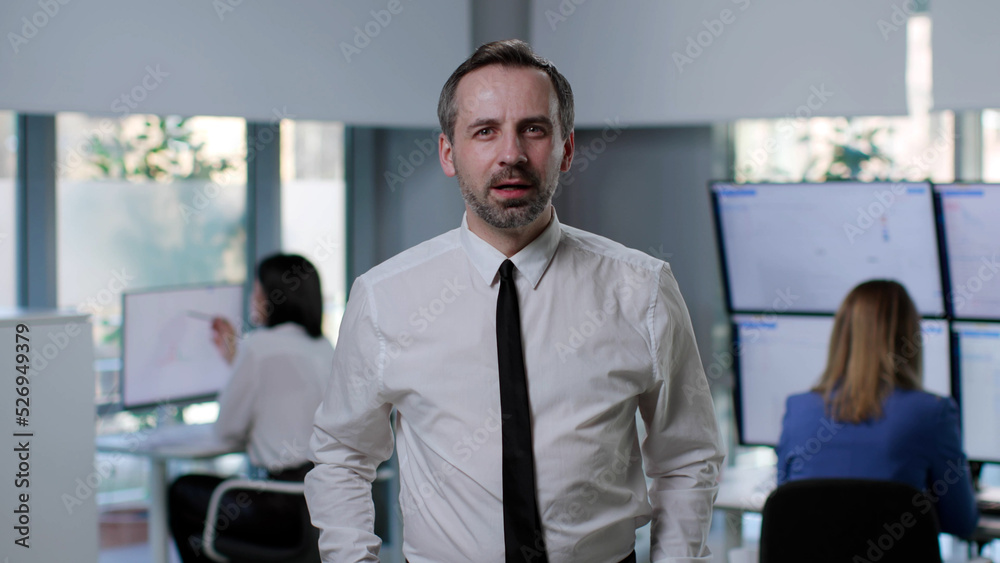Excited mature trader looking at screen with financial data Excited mature trader looking at screen with financial data
