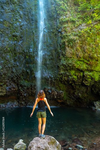 A young woman looking at the impressive waterfall at the Levada do Caldeirao Verde  Queimadas  Madeira