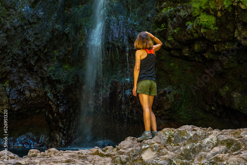 A young woman at the waterfall at the end of the waterfall trail at Levada do Caldeirao Verde  Queimadas  Madeira