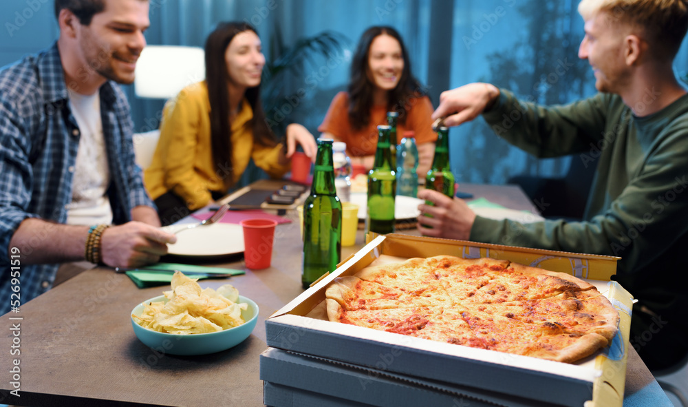 Friends eating pizza together at home Friends eating pizza together at home