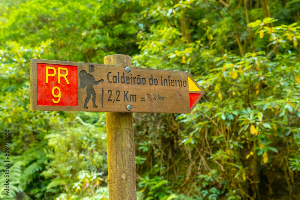Signs on the trekking trail next to the waterfall in Levada do Inferno, Queimadas, Madeira