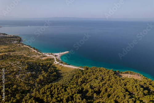 A panoramic view of the sea and a sandy beach in a rocky area.