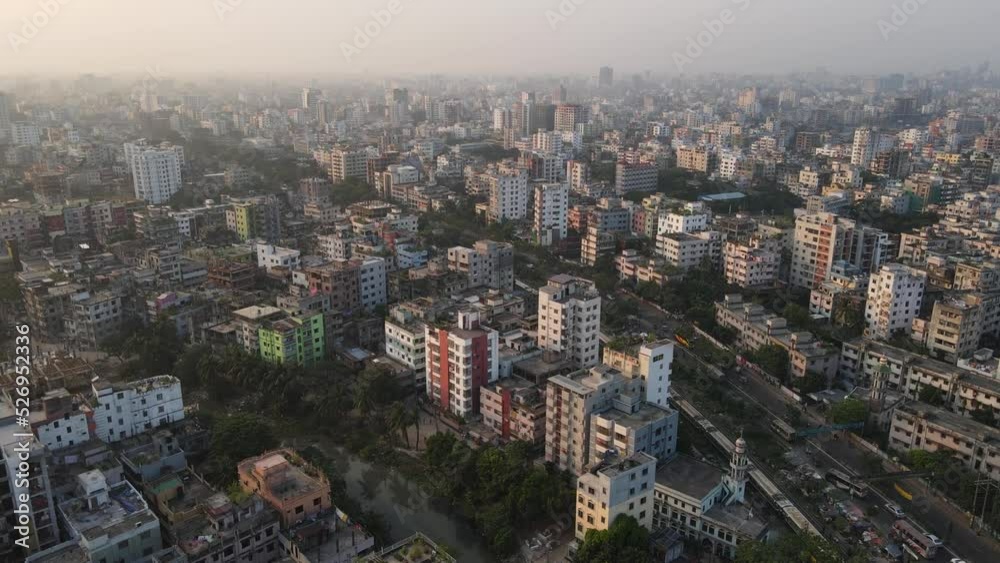 Dhaka city aerial view. Train passing through city. Bangladesh densely populated modern town. Top view. Dhaka city aerial view. Train passing through city. Bangladesh densely populated modern town. Top view.