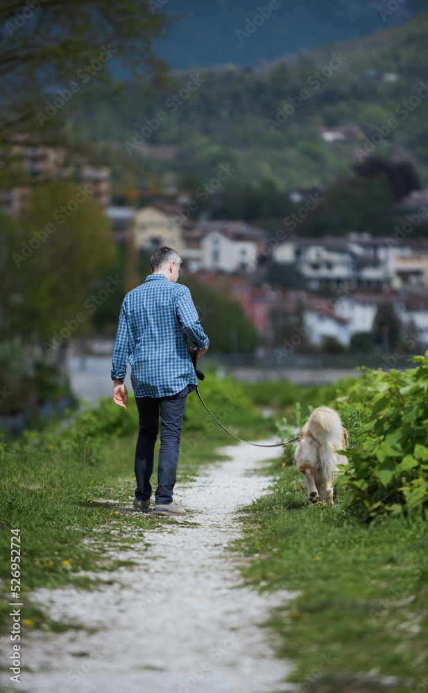 Man and dog walking in nature Man and dog walking in nature