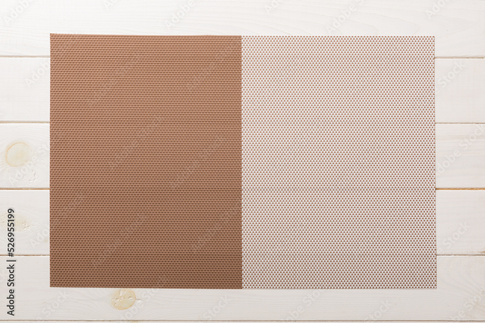 Fototapeta premium Top view of brown tablecloth for food on wooden background. Empty space for your design