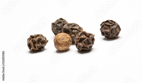 heap of black pepper, close-up macro photo. front view on white background