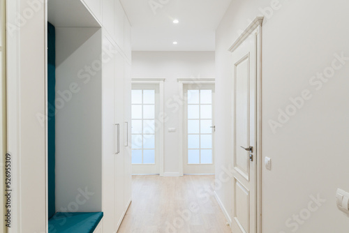 a large bright corridor with a mirror in the new design of the interior of the house
