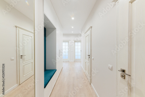 a large bright corridor with a mirror in the new design of the interior of the house