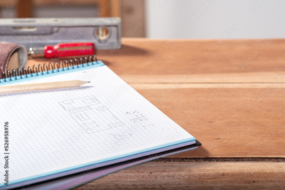 pencil plan, measurements noted in a notebook for a house to be built
pencil plan, measurements noted in a notebook for a house to be built