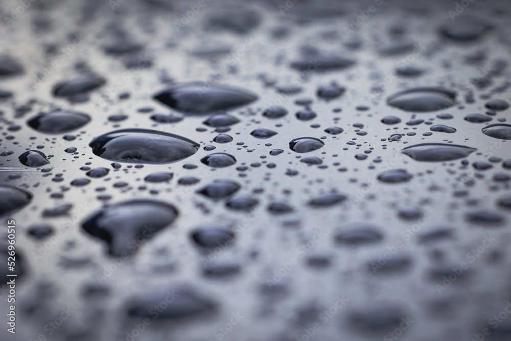 Close up on a raindrops on a car body surface Close up on a raindrops on a car body surface