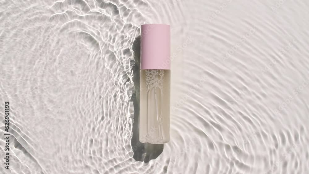Cosmetic bottle, vial on water surface with drops. Pure water with reflections sunlight and shadows. Slow motion of waves water. Video of packaging for design, advertising, products. 4k Cosmetic bottle, vial on water surface with drops. Pure water with reflections sunlight and shadows. Slow motion of waves water. Video of packaging for design, advertising, products. 4k