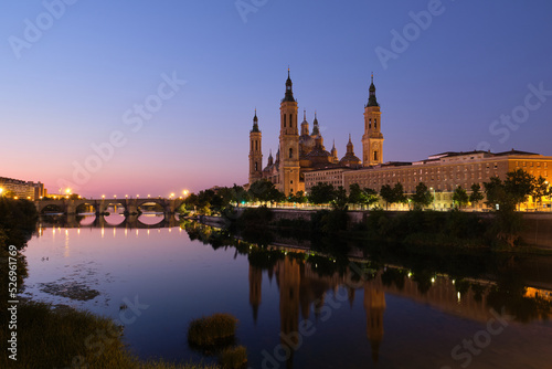 Illuminated Basilica of Our Lady of the Pillar and Ebro river at sunrise in Zaragoza, Spain. El Pilar de Zaragoza.