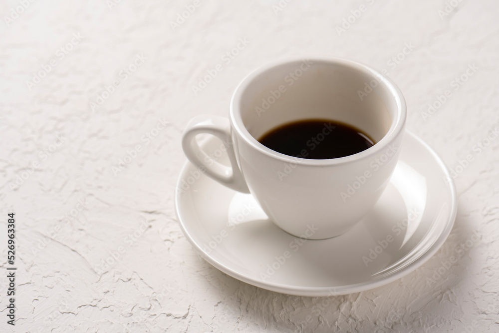 close-up shot of cup of coffee on white tabletop close-up shot of cup of coffee on white tabletop